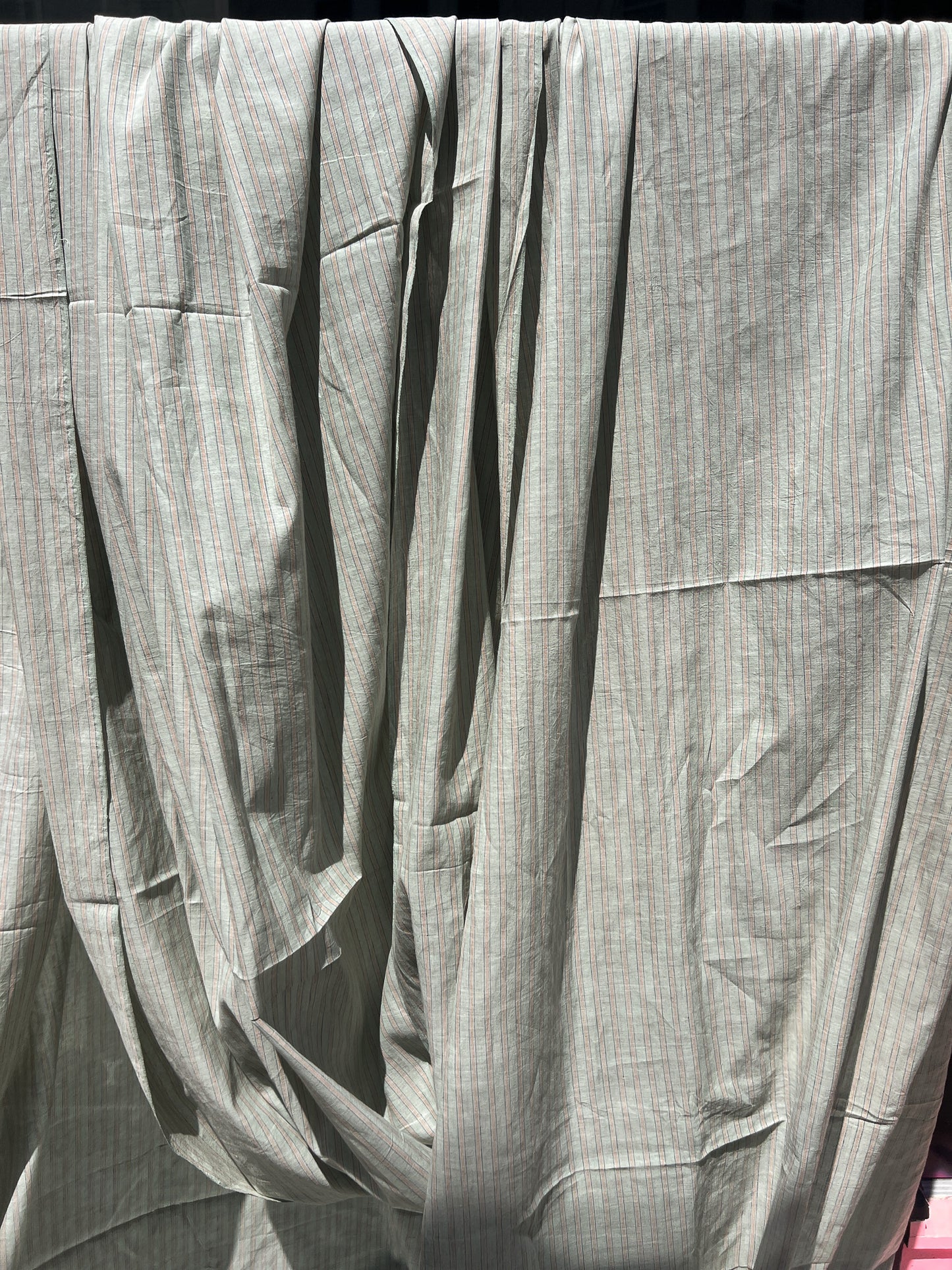 green cotton with blue and orange pinstripe