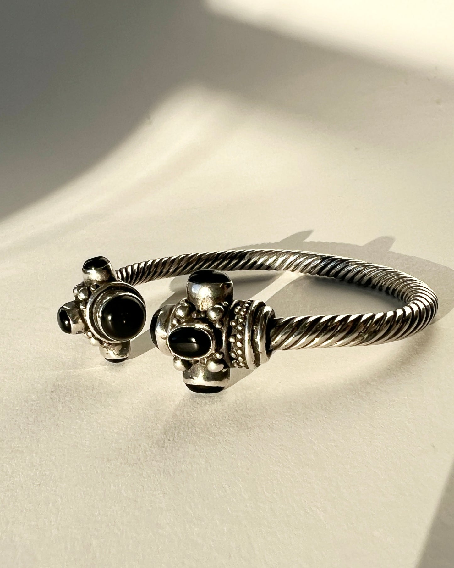 twisted silver bracelet with onyx cabochons