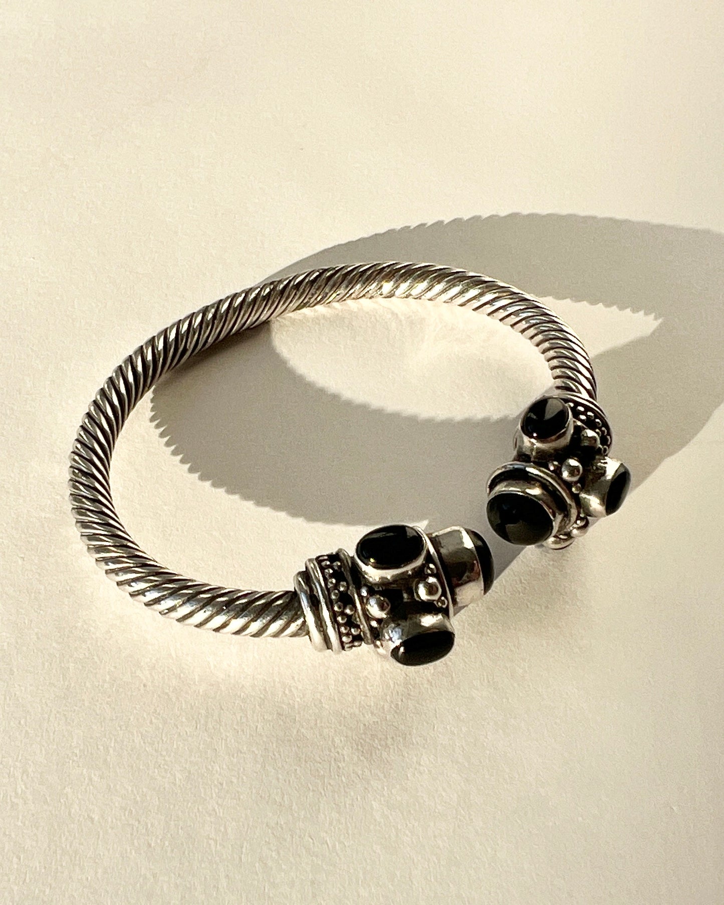 twisted silver bracelet with onyx cabochons