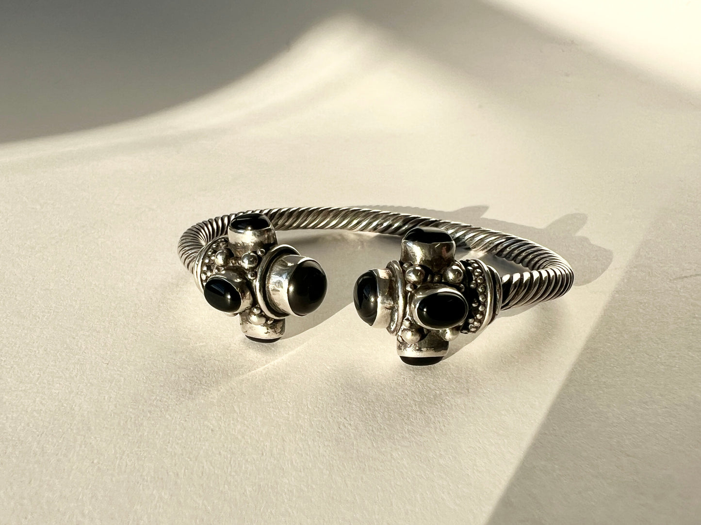 twisted silver bracelet with onyx cabochons